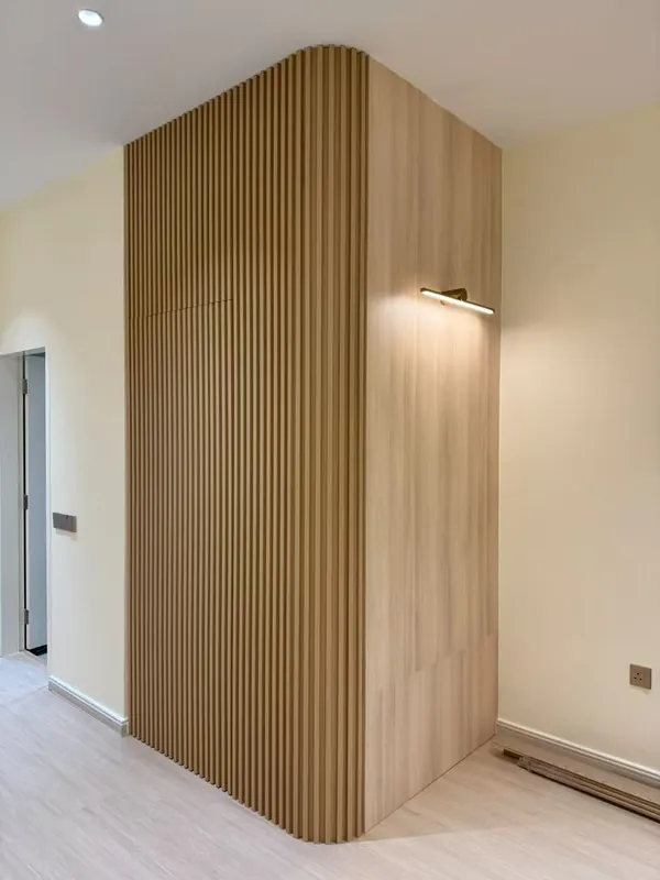Curved fluted timber feature wall at the entrance — Johor Bahru