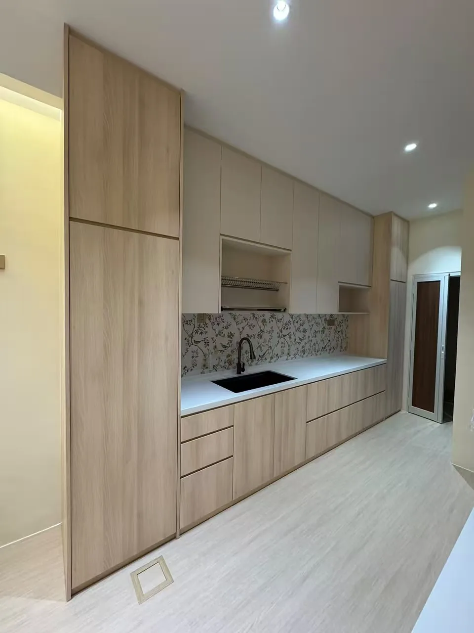 Wood and cream kitchen cabinetry with tall units