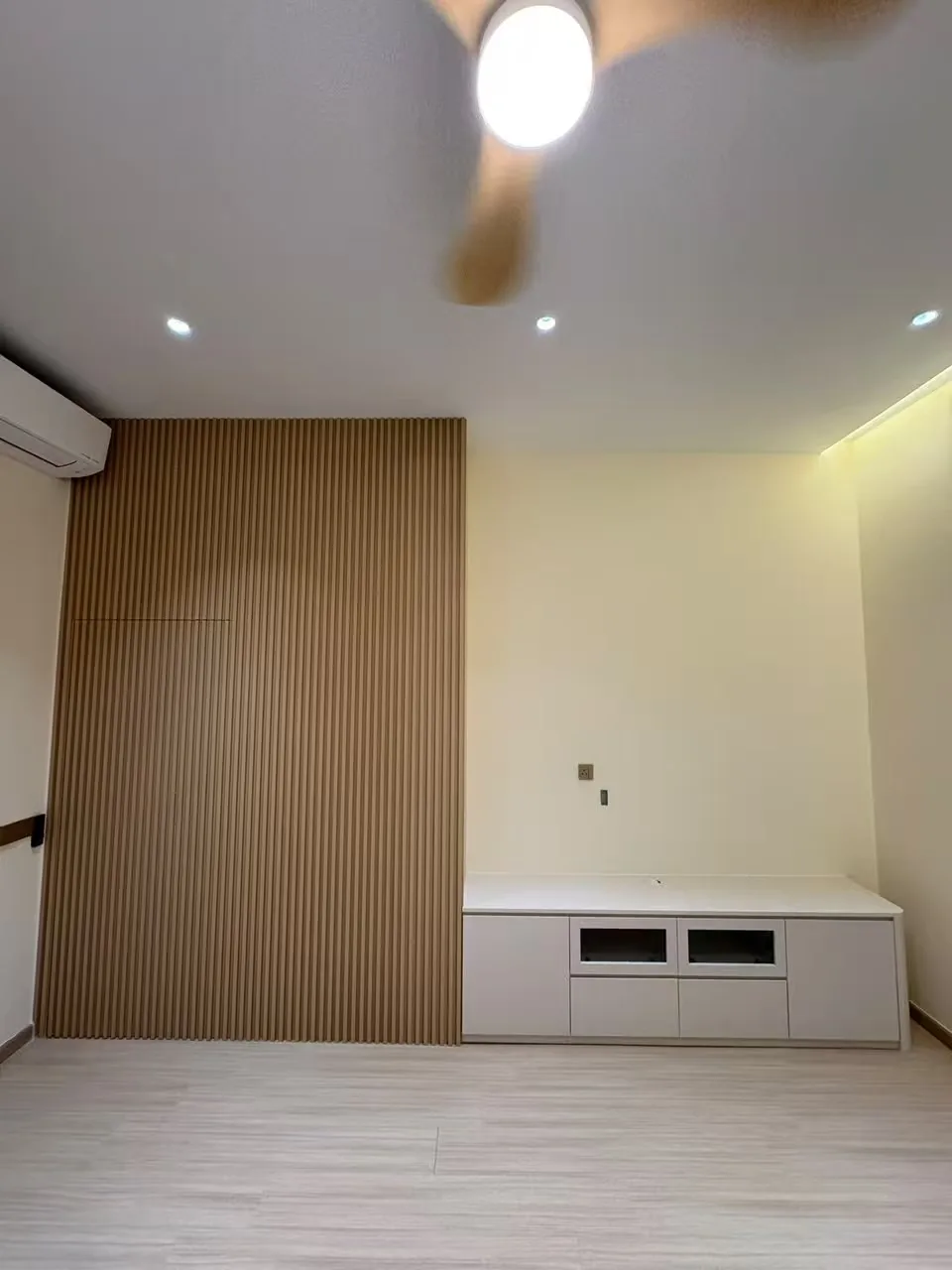 Bedroom fluted feature wall with a white low TV console