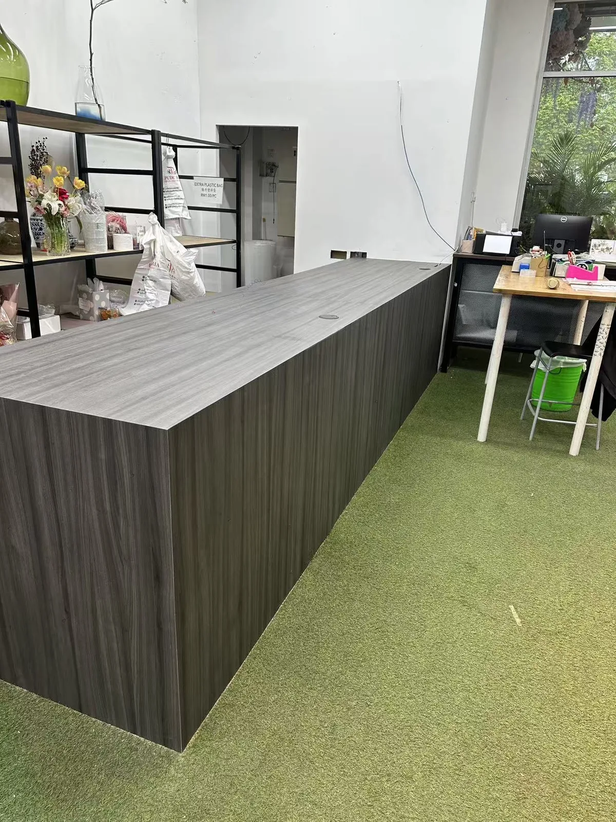 Custom cashier counter with a drawer bank and display shelving